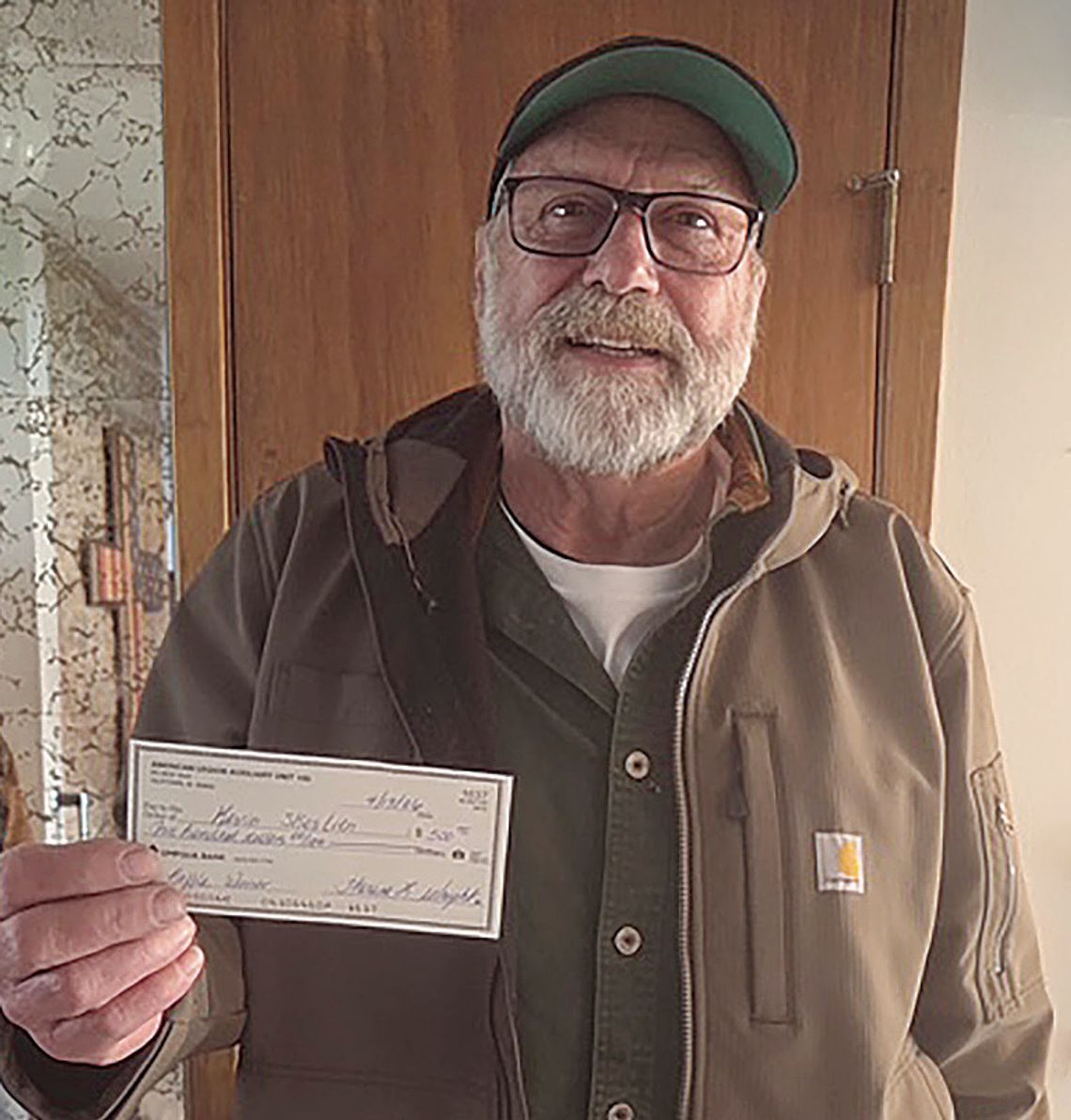 Raffle winner gives back